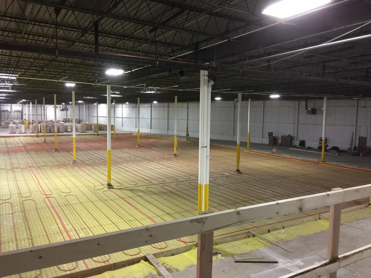 Radiant floor heating tubing installed across a warehouse floor